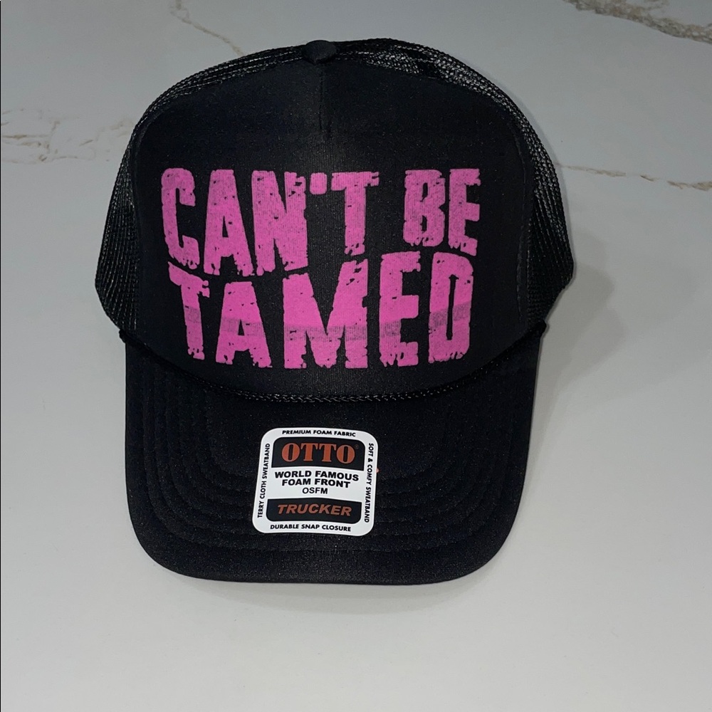 CAN’T BE TAMED Black Trucker Hat with Pink Text